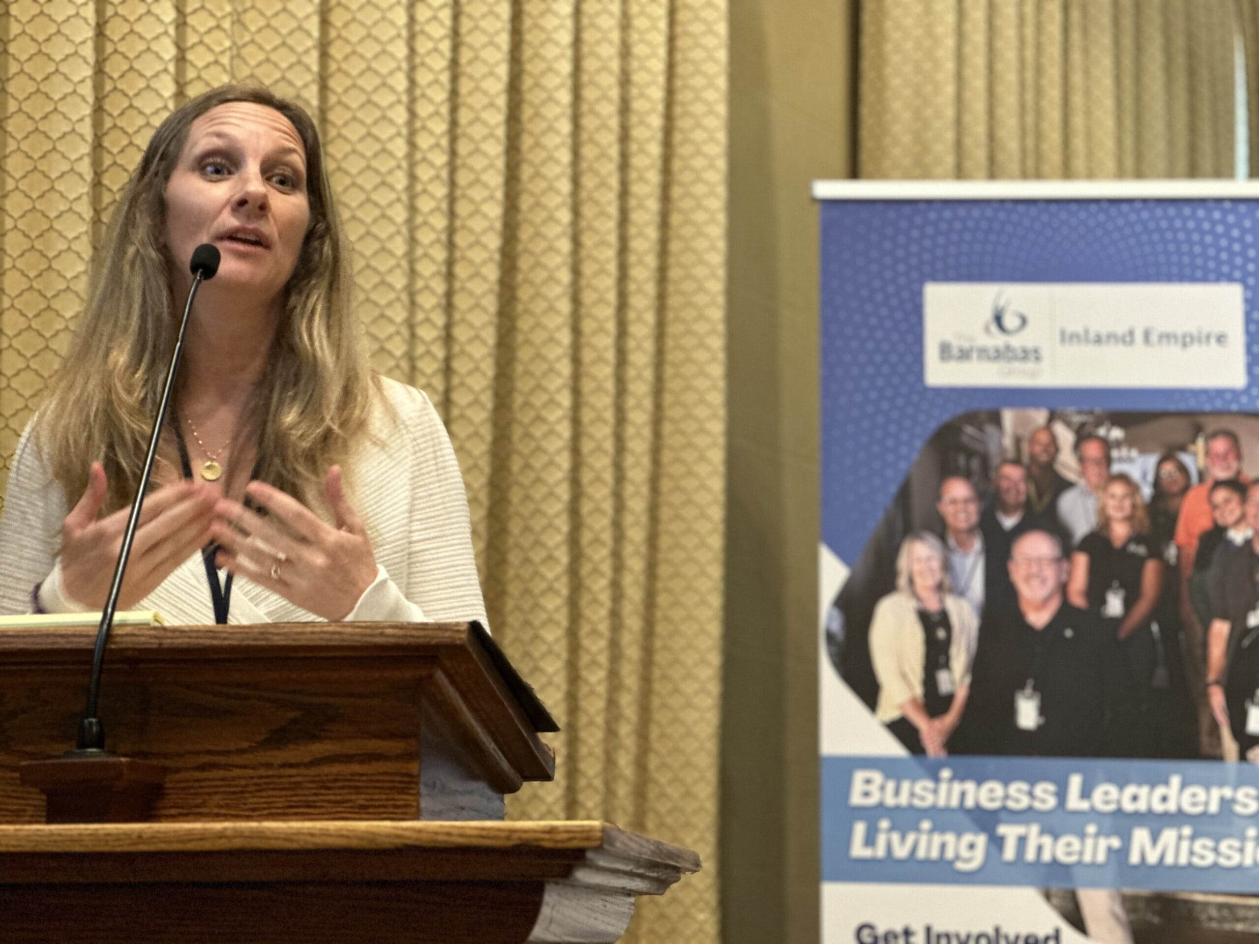 Woman speaking at a business leadership event.